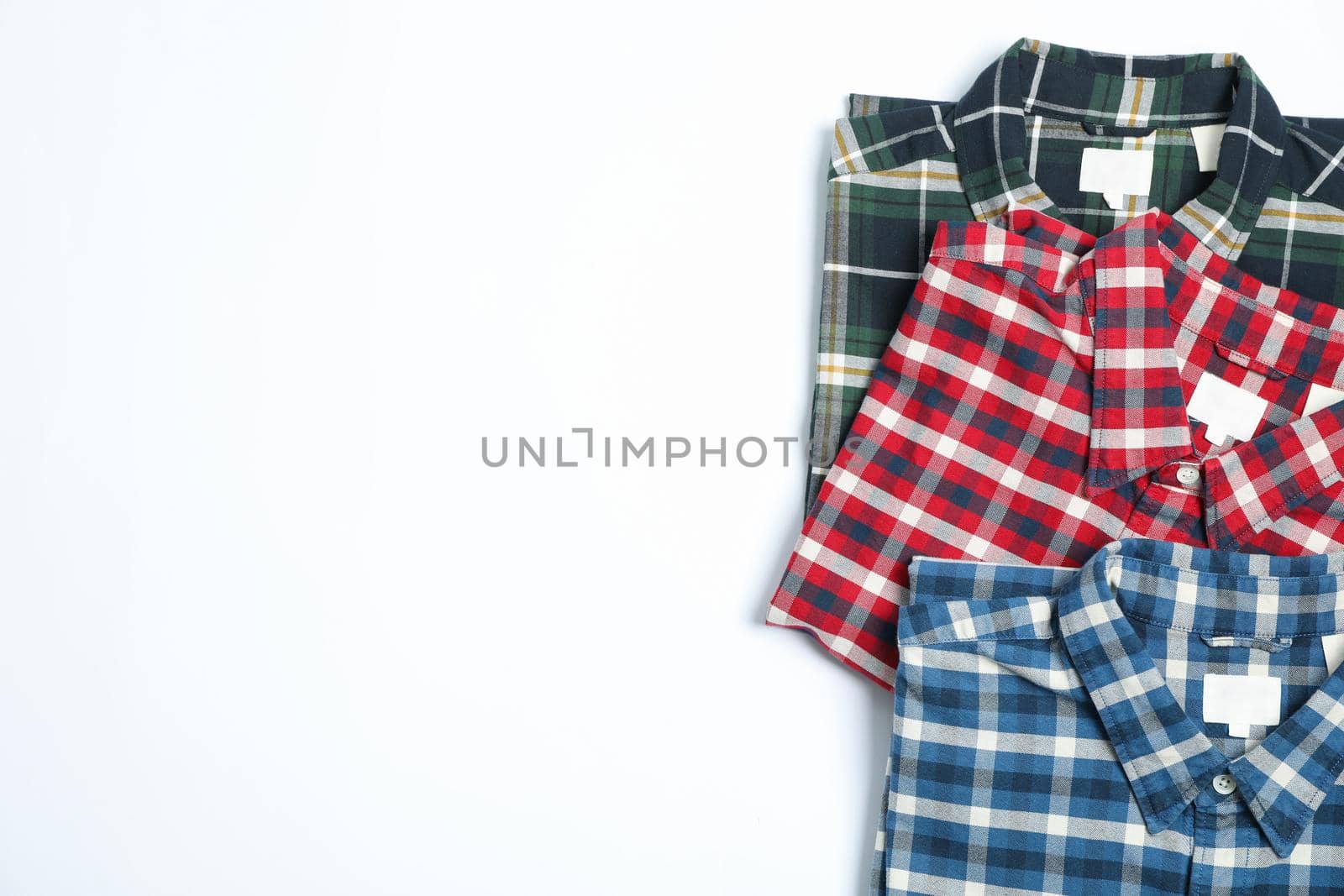 Flat lay with shirts on white background, copy space by AtlasCompany