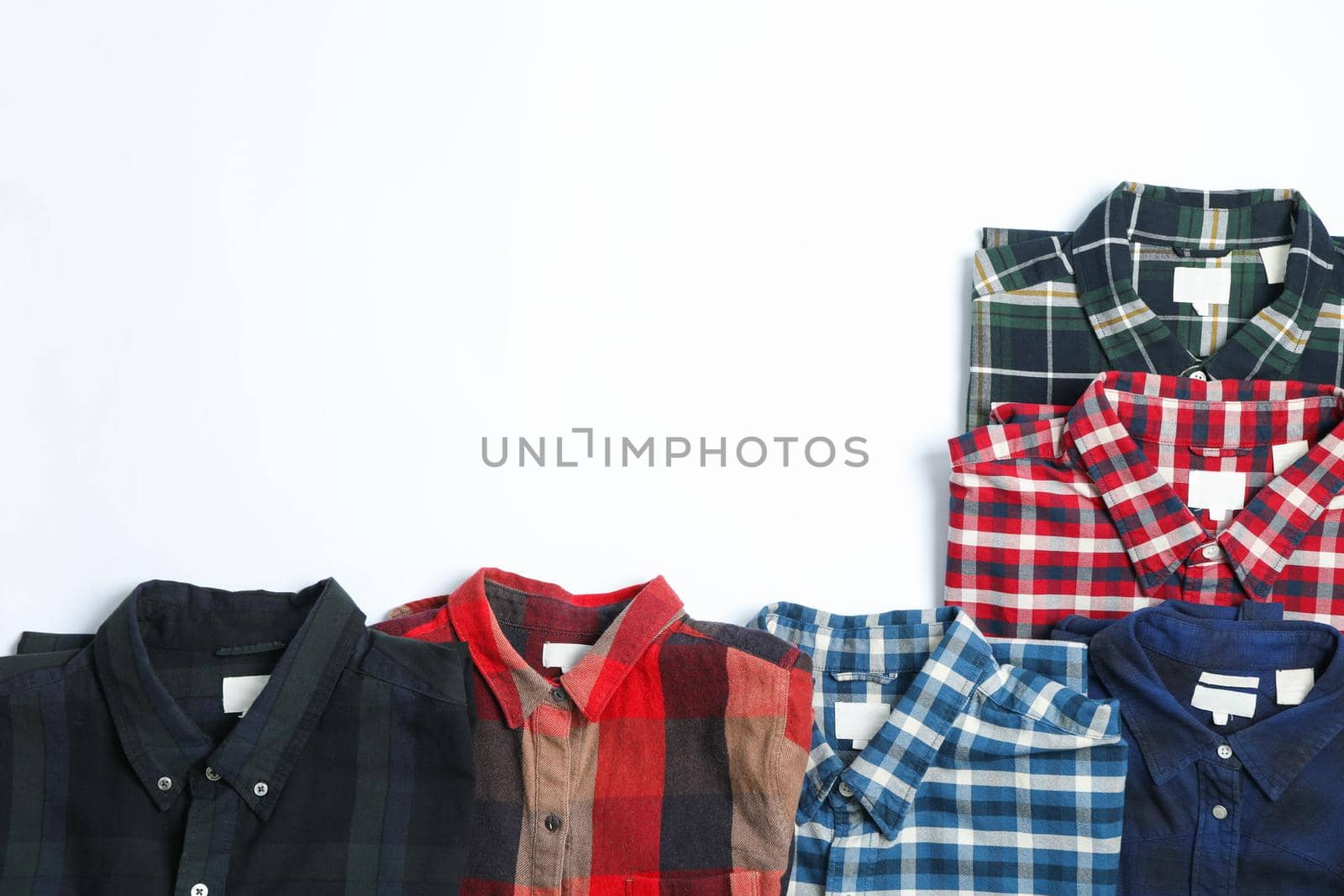 Flat lay with different shirts on white background, copy space by AtlasCompany