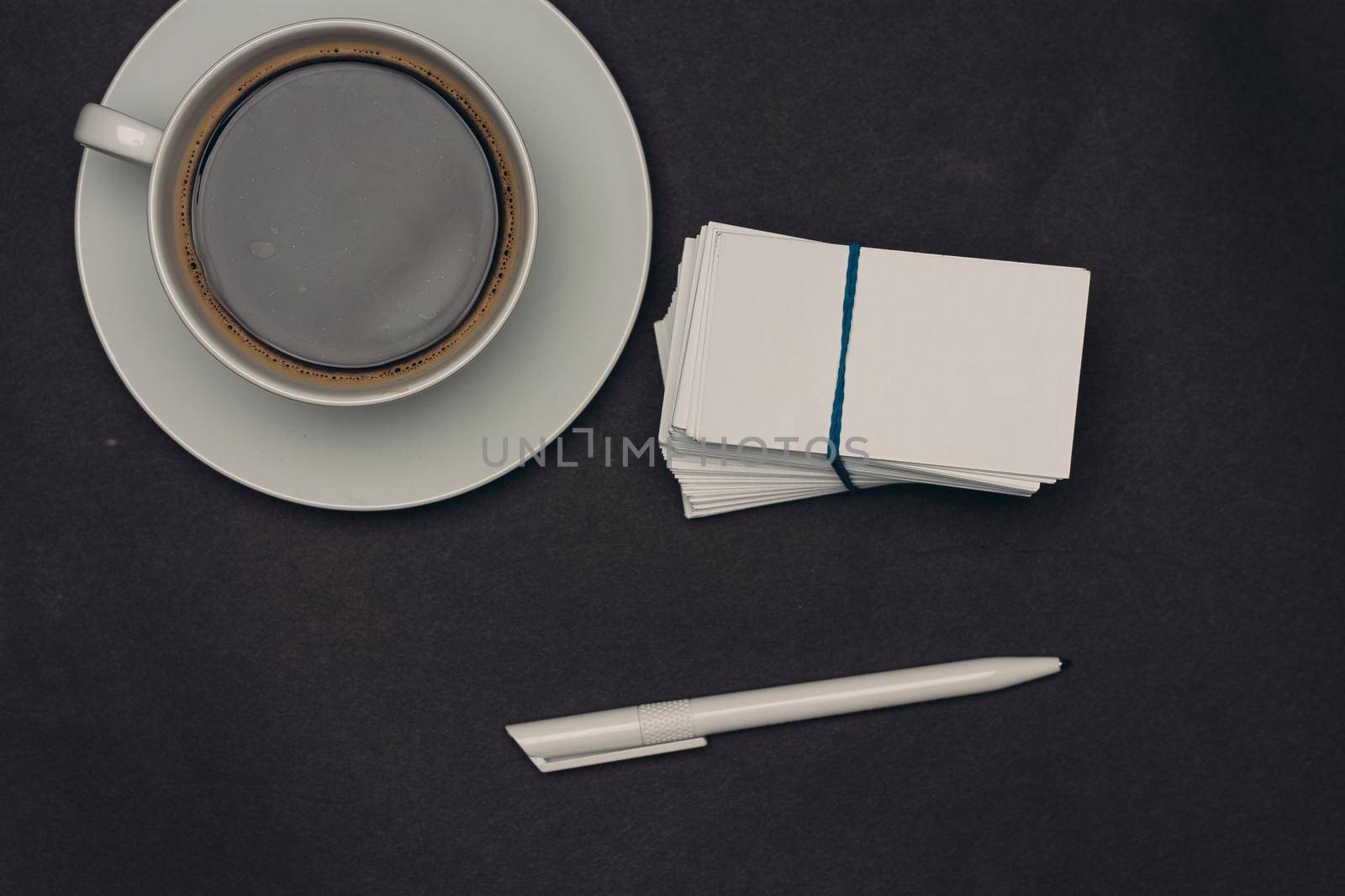 coffee cup desktop business card pen office close-up. High quality photo