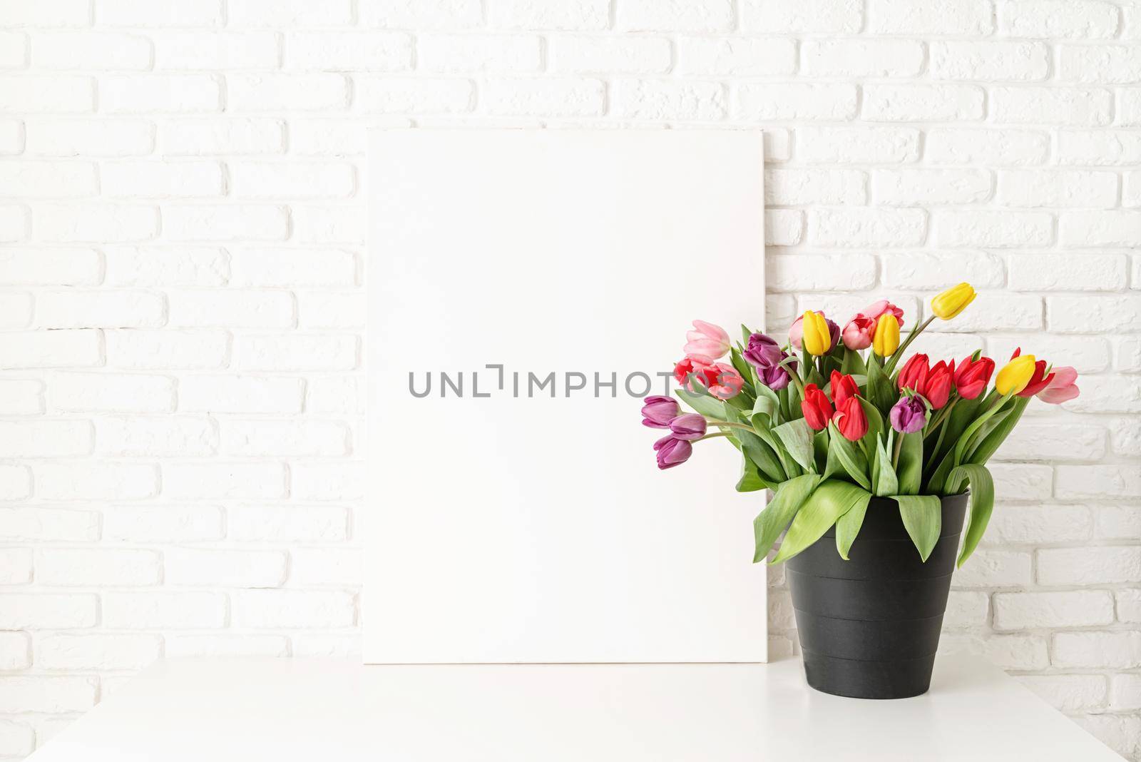 Mock up design. Mock up with Frame and bucket of tulips on white brick wall background