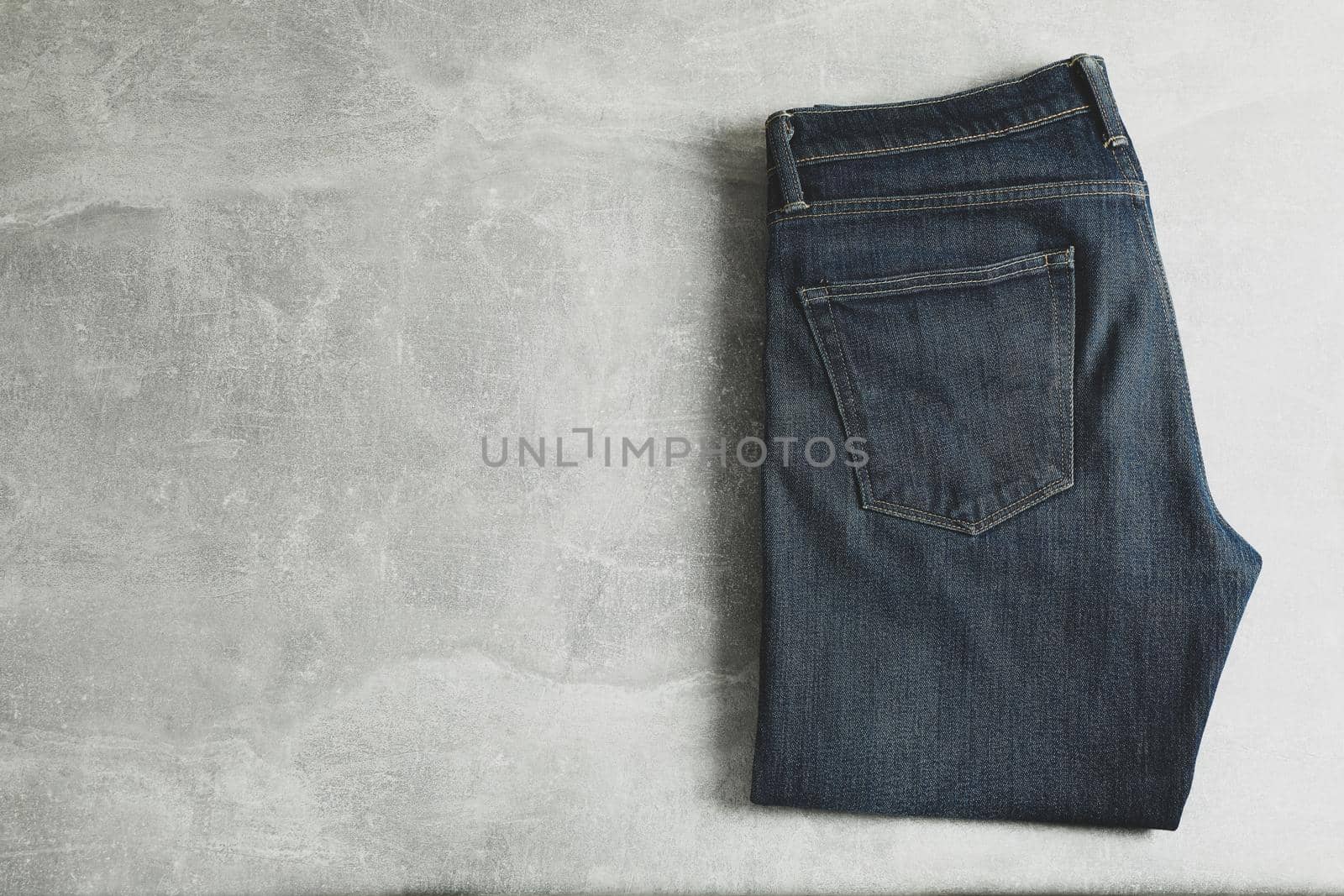 Classic jeans on grey background, space for text by AtlasCompany