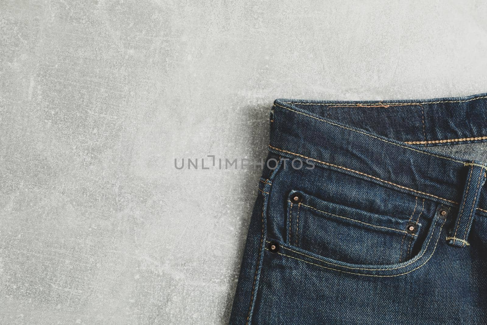 Classic jeans on grey background, space for text by AtlasCompany