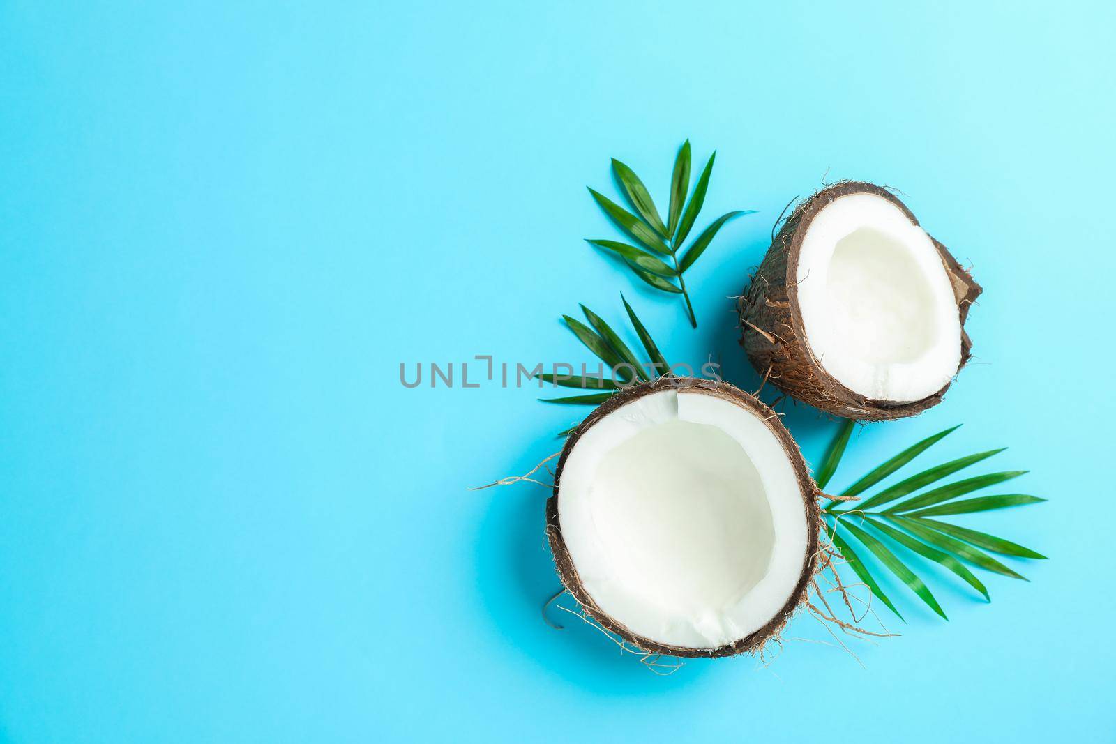 Split tropical coconut on color background, space for text