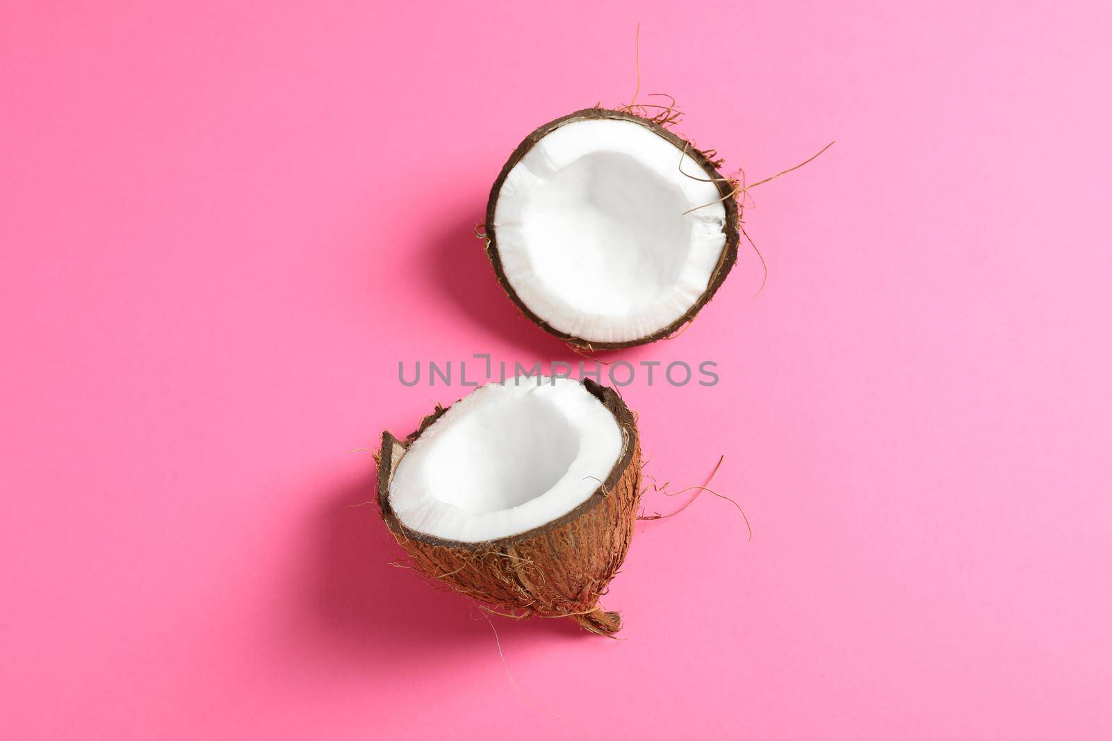 Split tropical coconut on color background, space for text