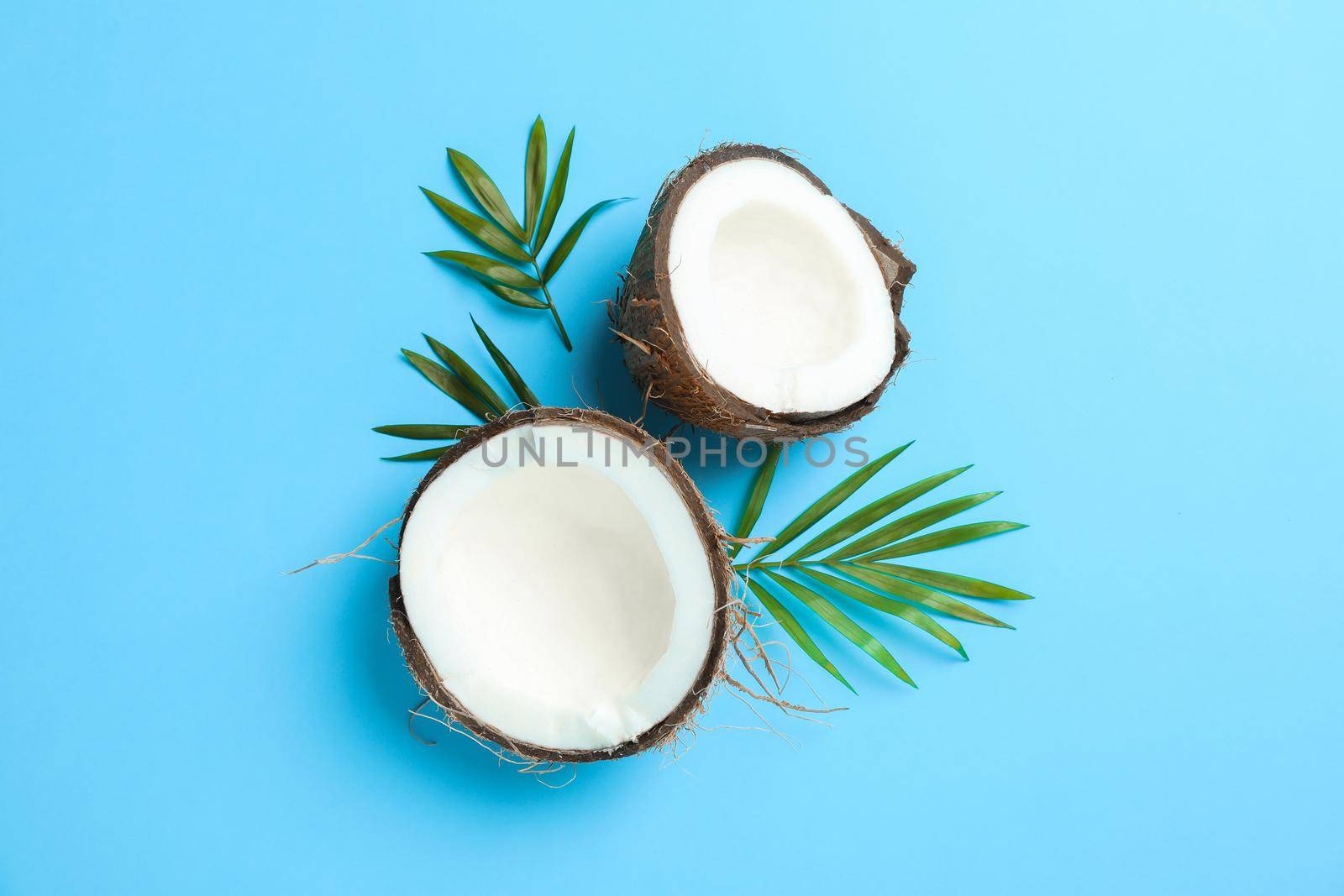 Split tropical coconut on color background, space for text