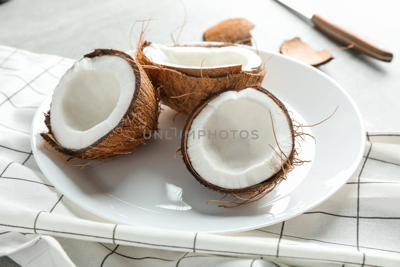 Plate with tropical coconuts on grey background, closeup