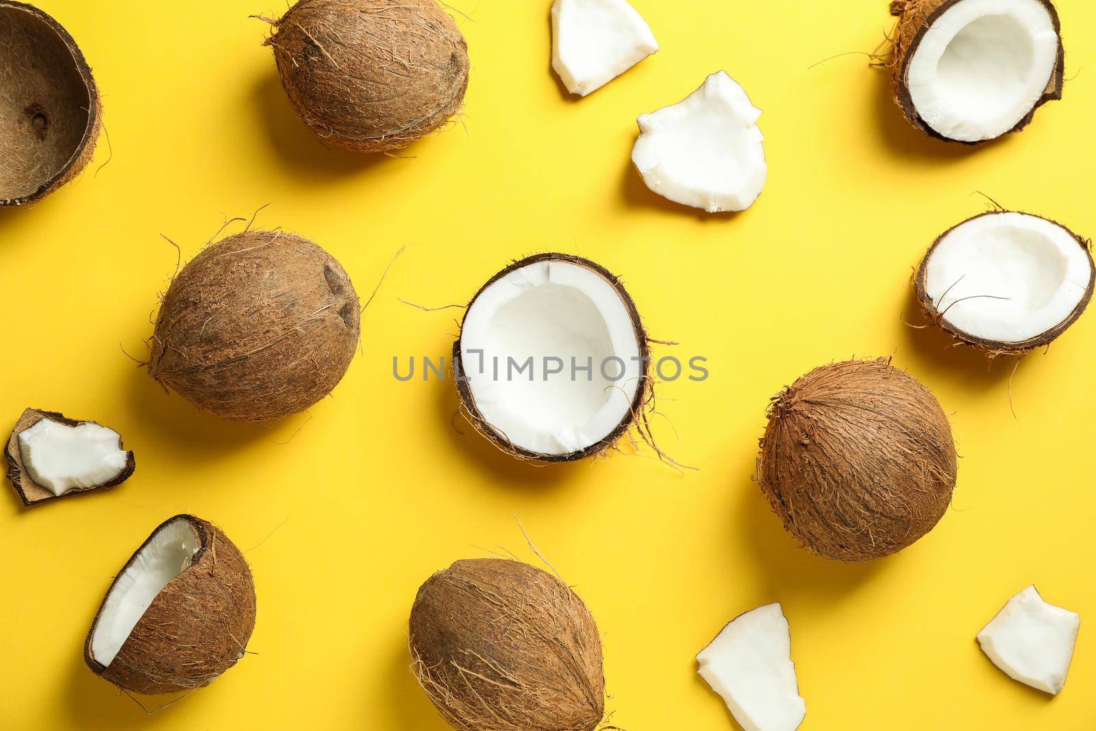 Flat lay composition with coconuts on color background by AtlasCompany