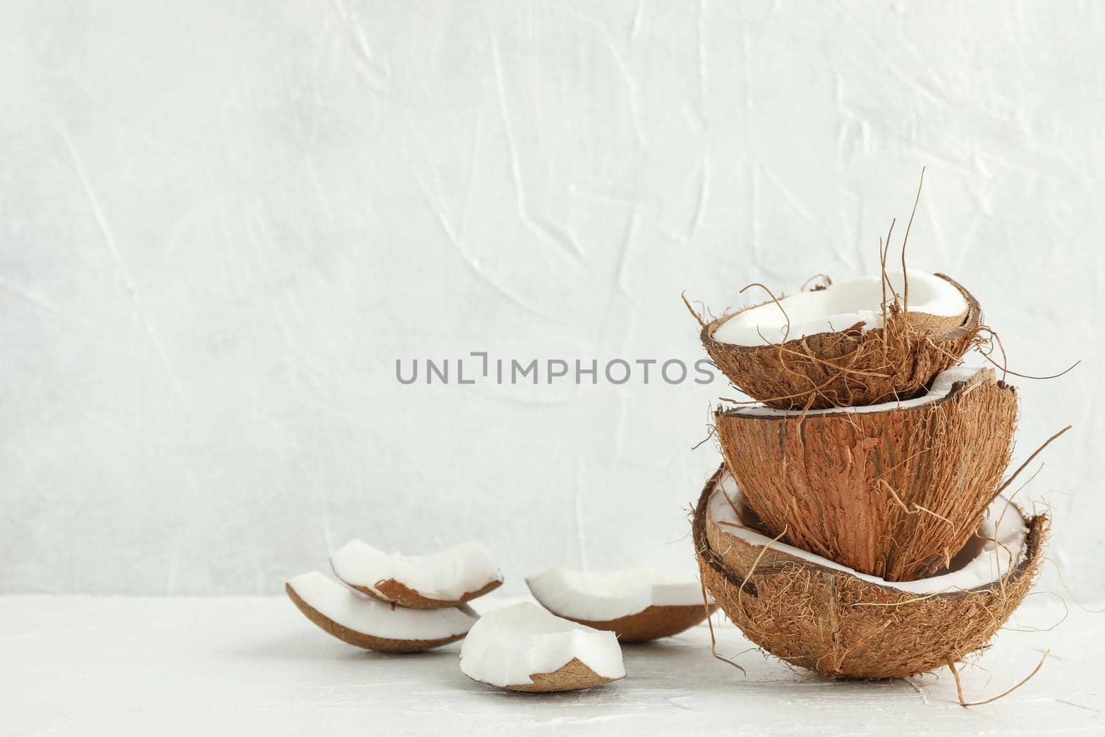 Stack tropical coconut on wooden table against white background