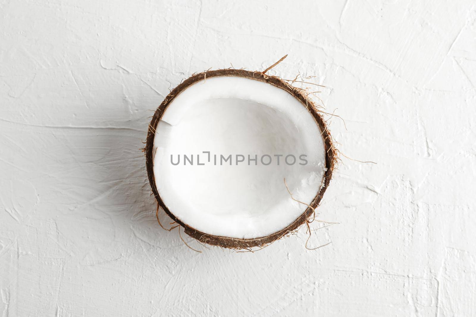 Half tropical coconut on white background, space for text