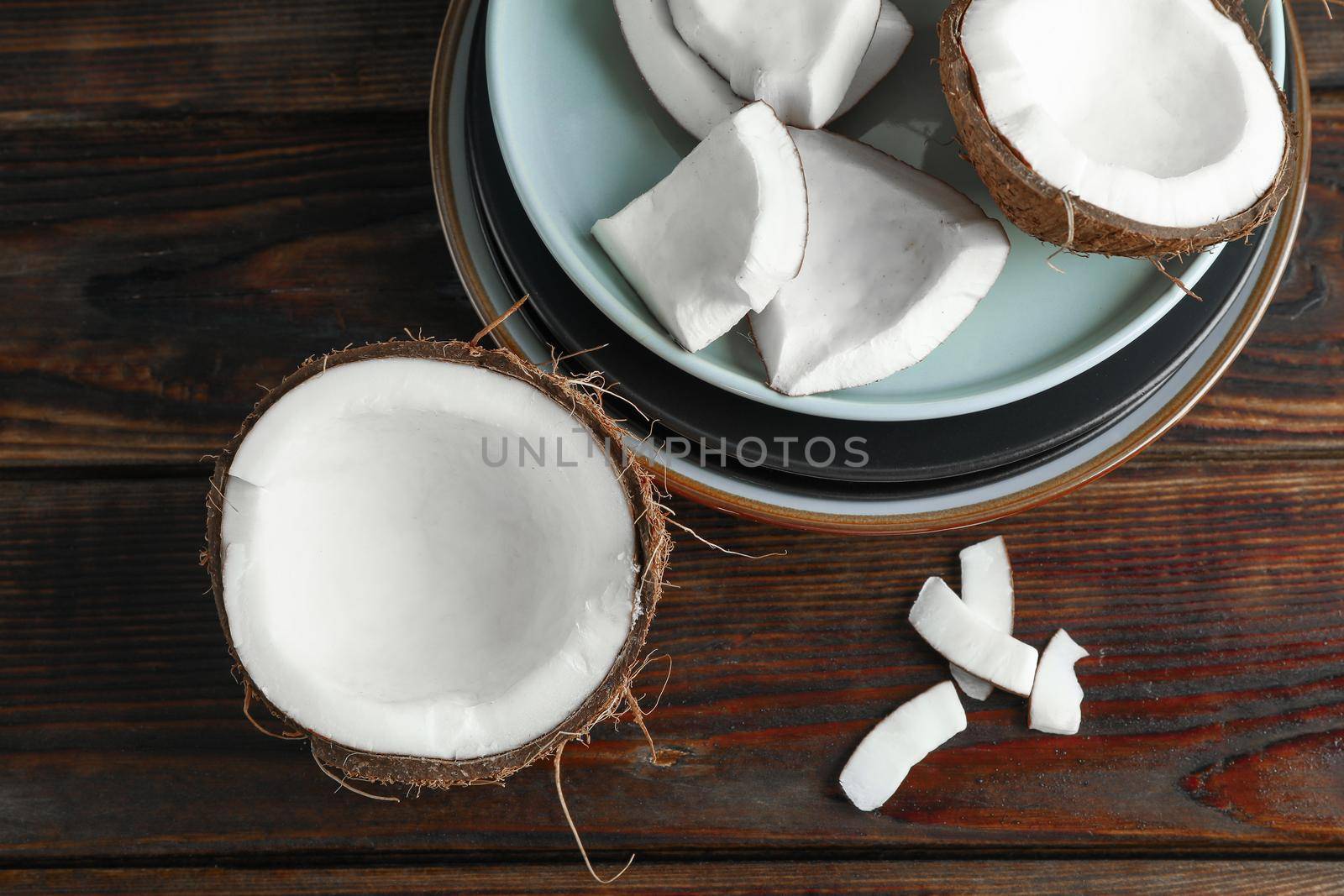 Coconuts on wooden table, top view