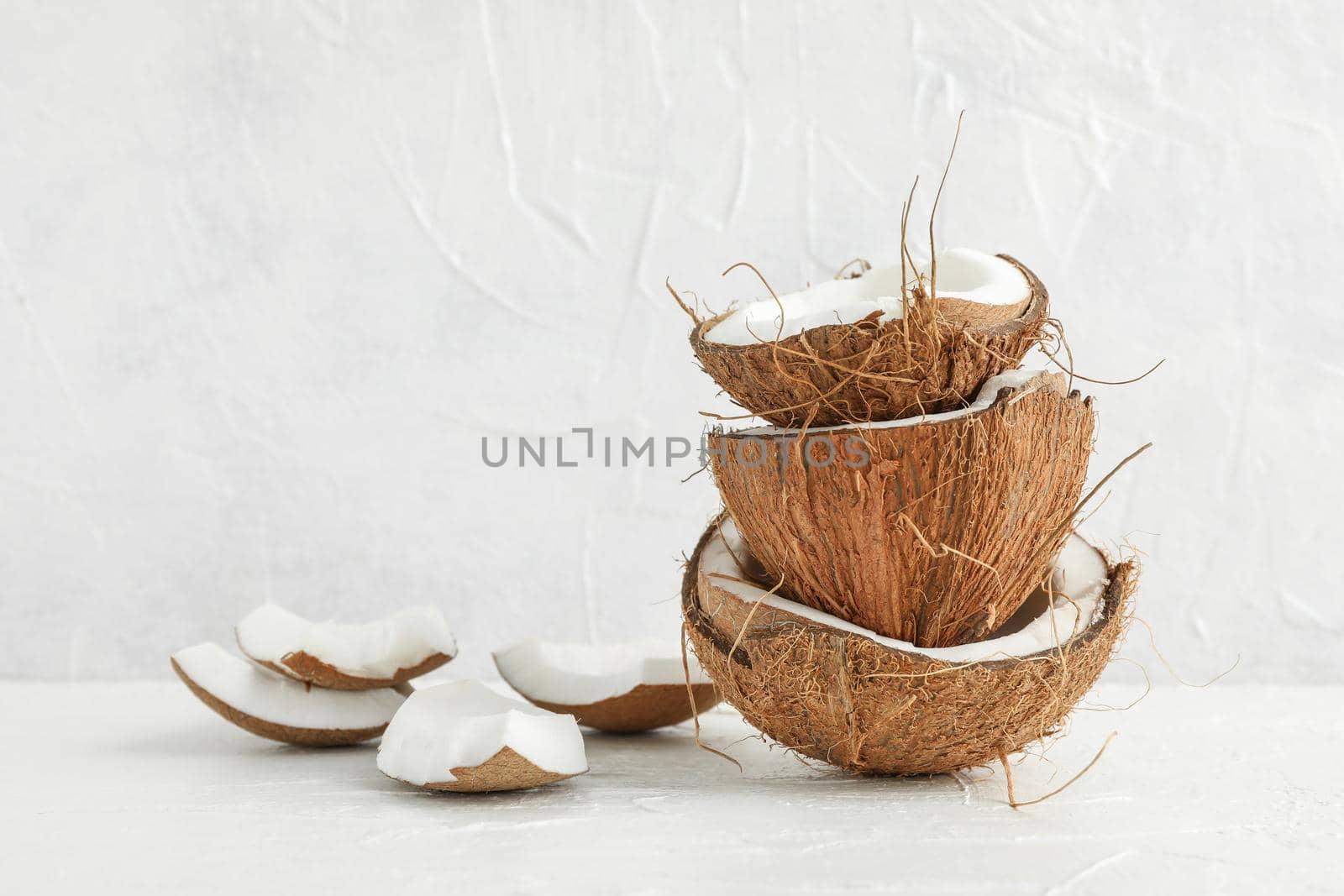 Stack tropical coconut on wooden table against white background