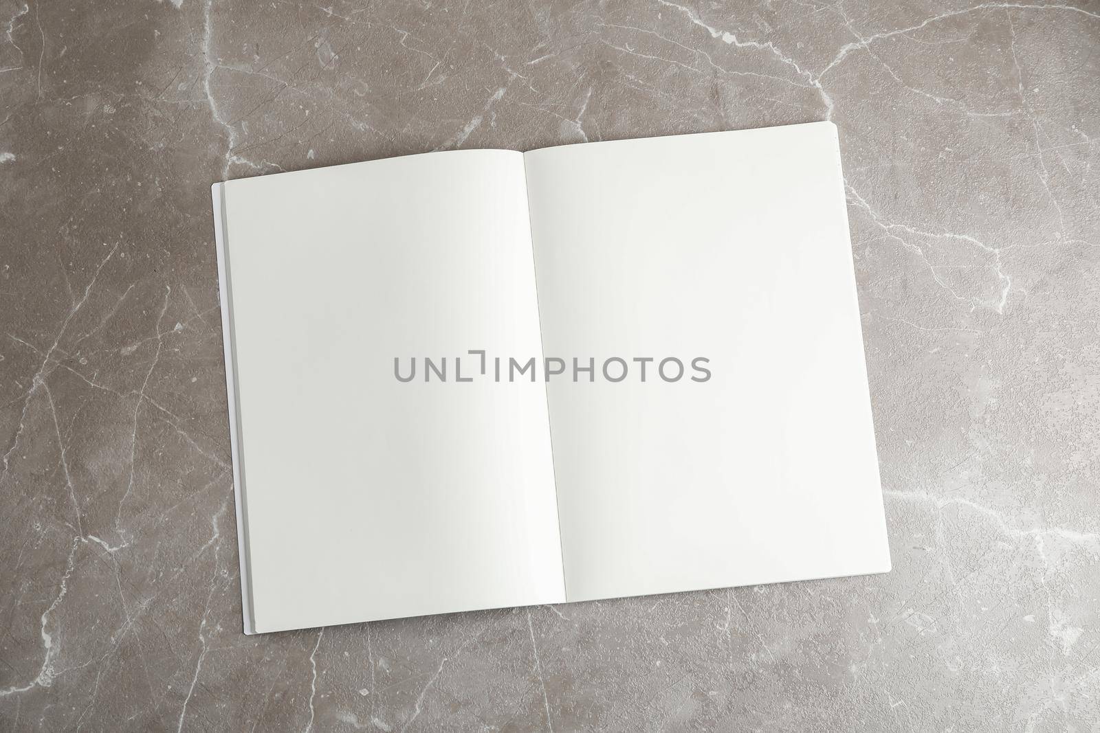 Clean copybook on grey table, space for text by AtlasCompany