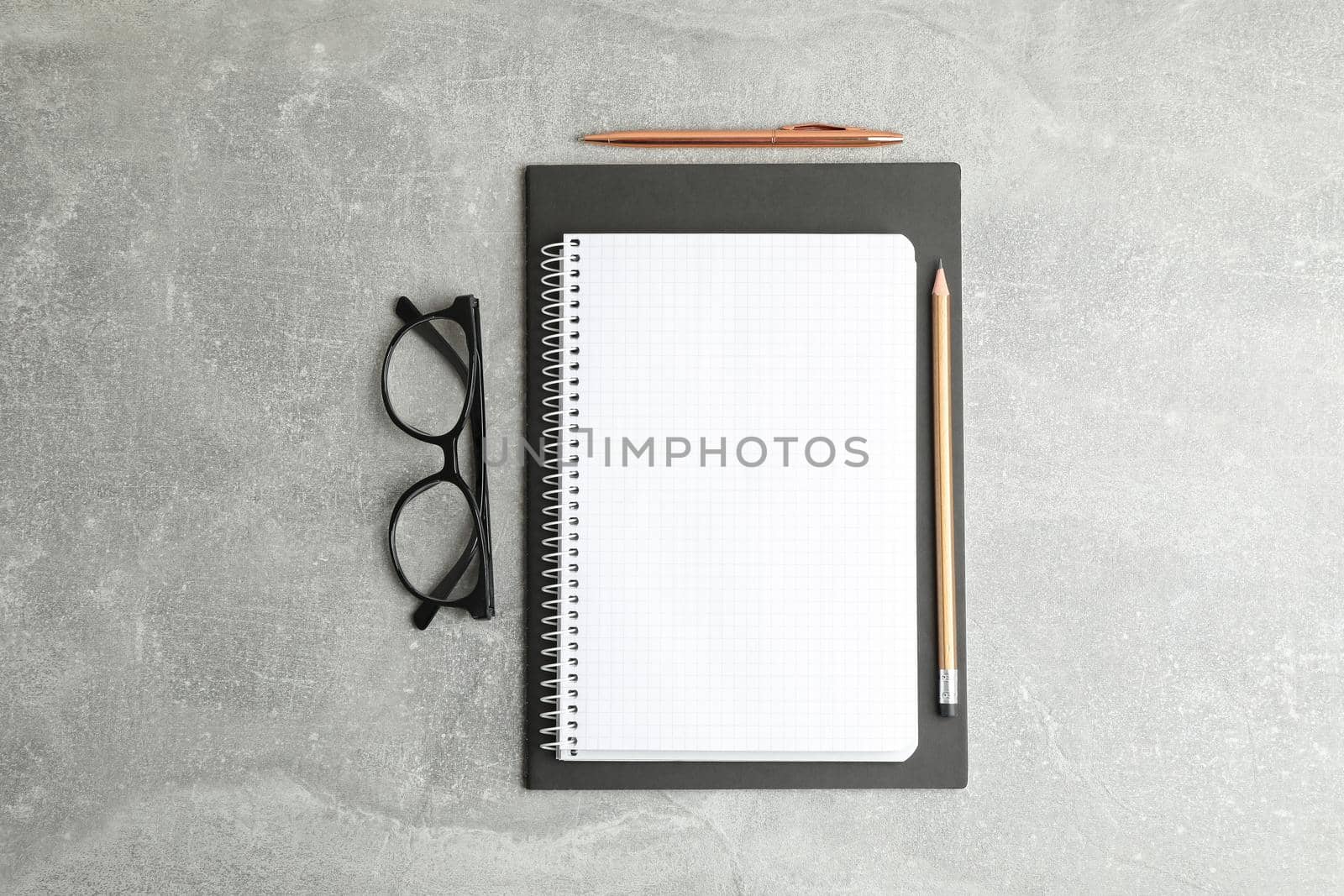 Flat lay composition with copybook and glasses, space for text