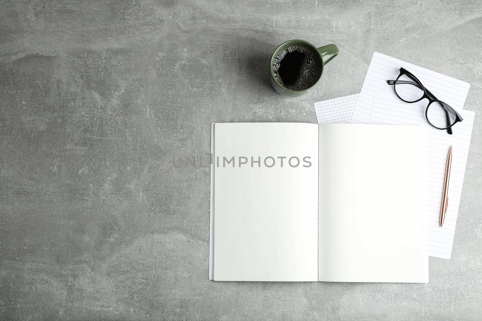 Flat lay composition with cup of coffee, copybooks and glasses, space for text