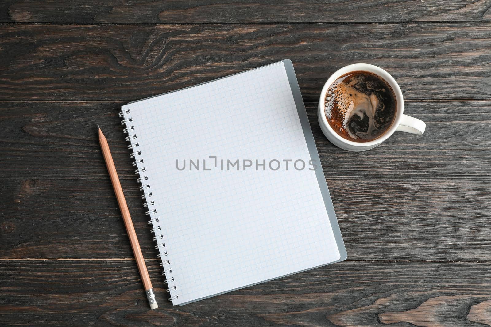 Flat lay composition with cup of coffee, copybook and pencil, space for text by AtlasCompany