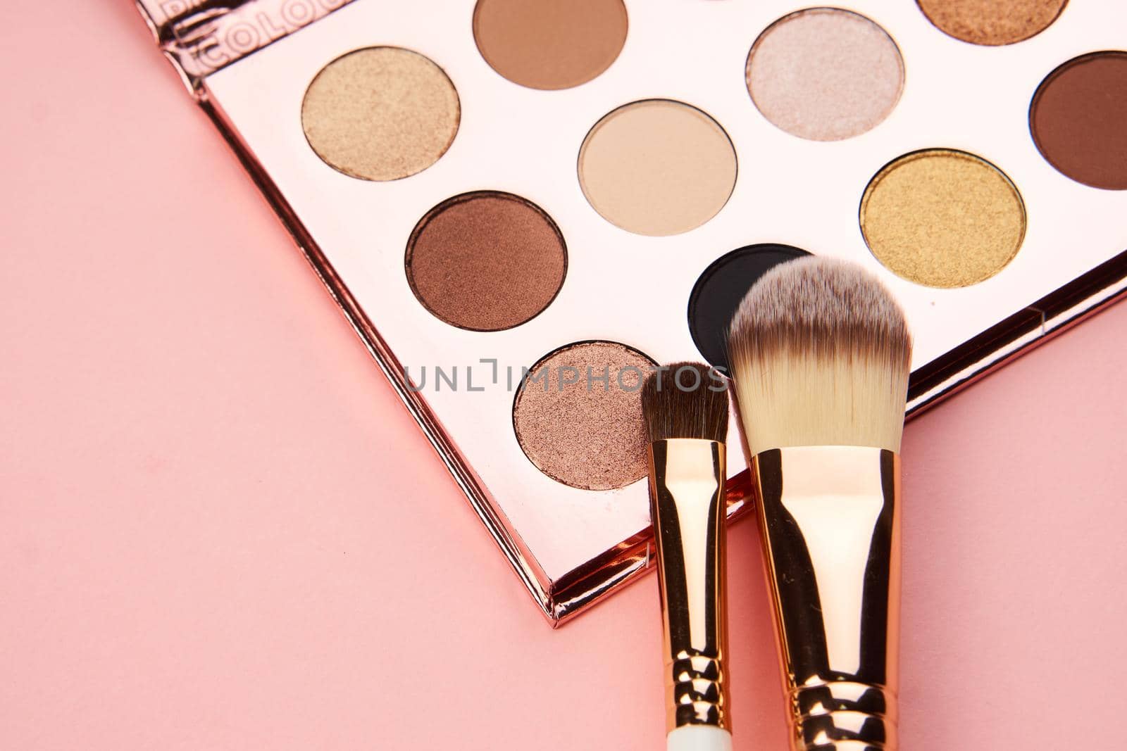 Female makeup decoration accessories on the table pink background top view. High quality photo