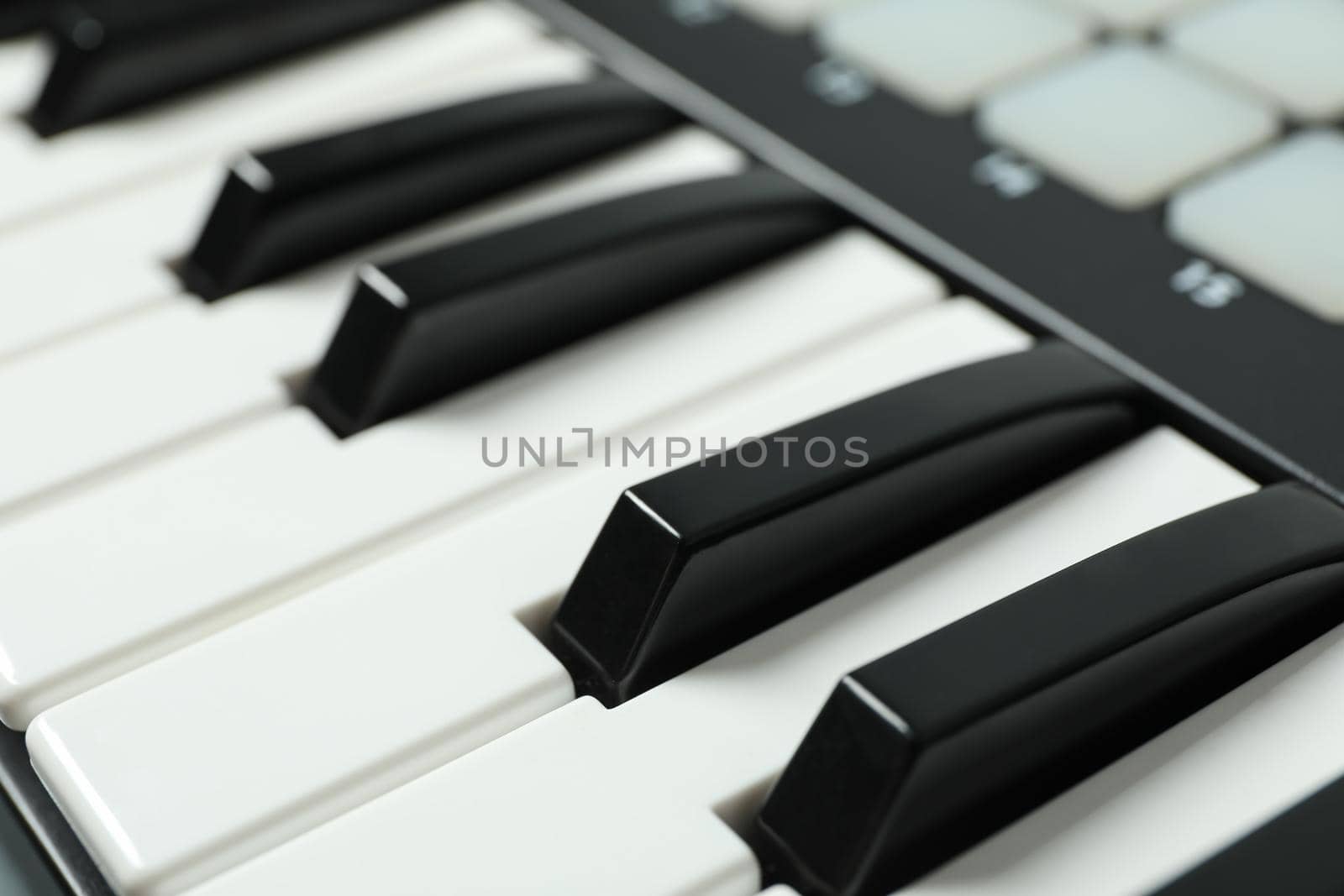 Portative modern midi keyboard as background, closeup