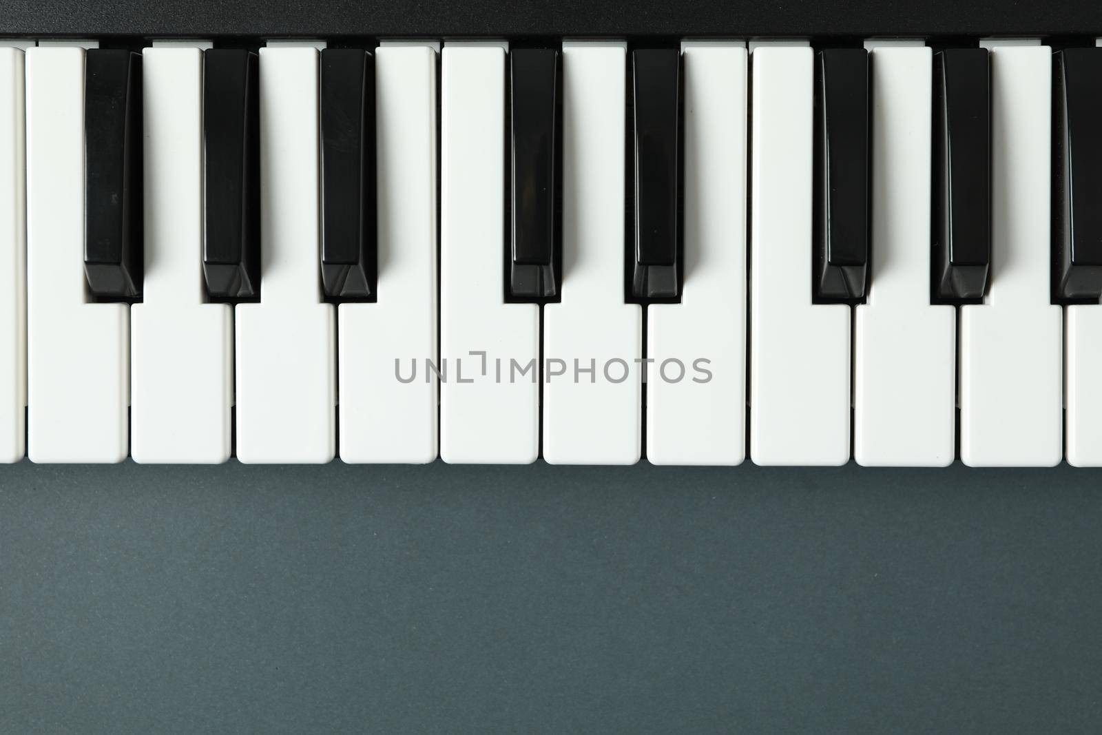 Piano keyboard on dark background, space for text