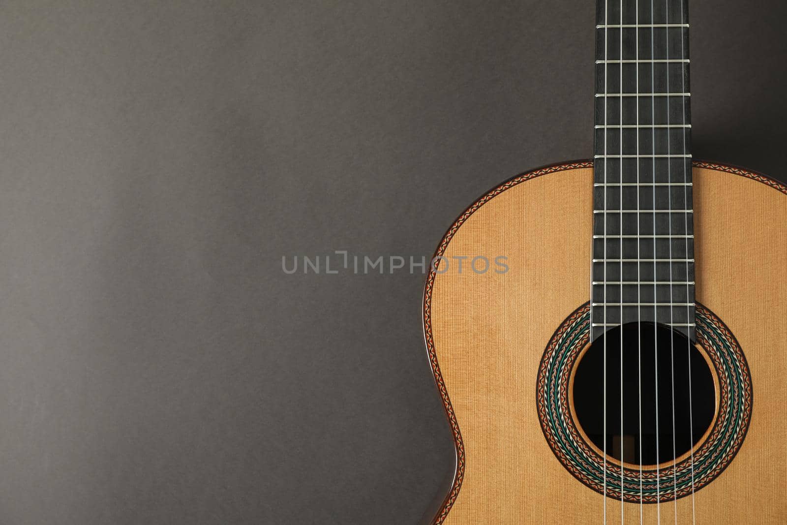 Beautiful classic guitar on dark background, space for text by AtlasCompany