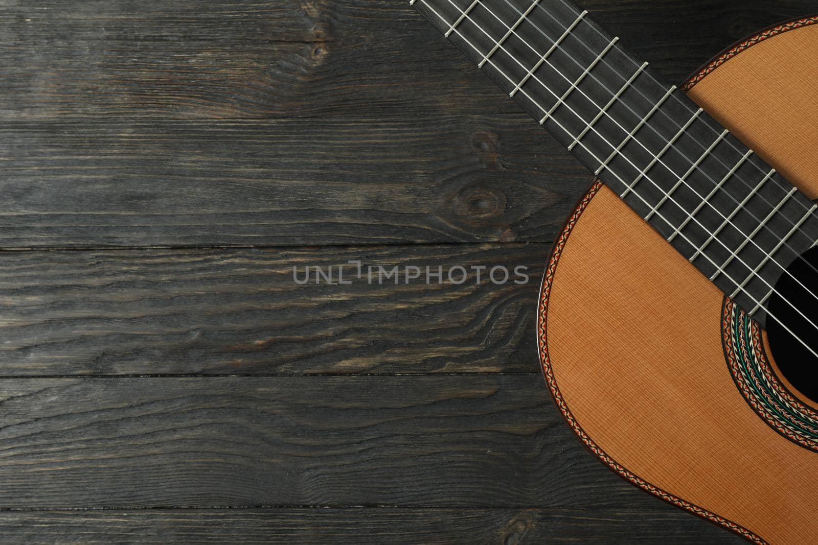 Beautiful six - string classic guitar on wooden background, space for text by AtlasCompany