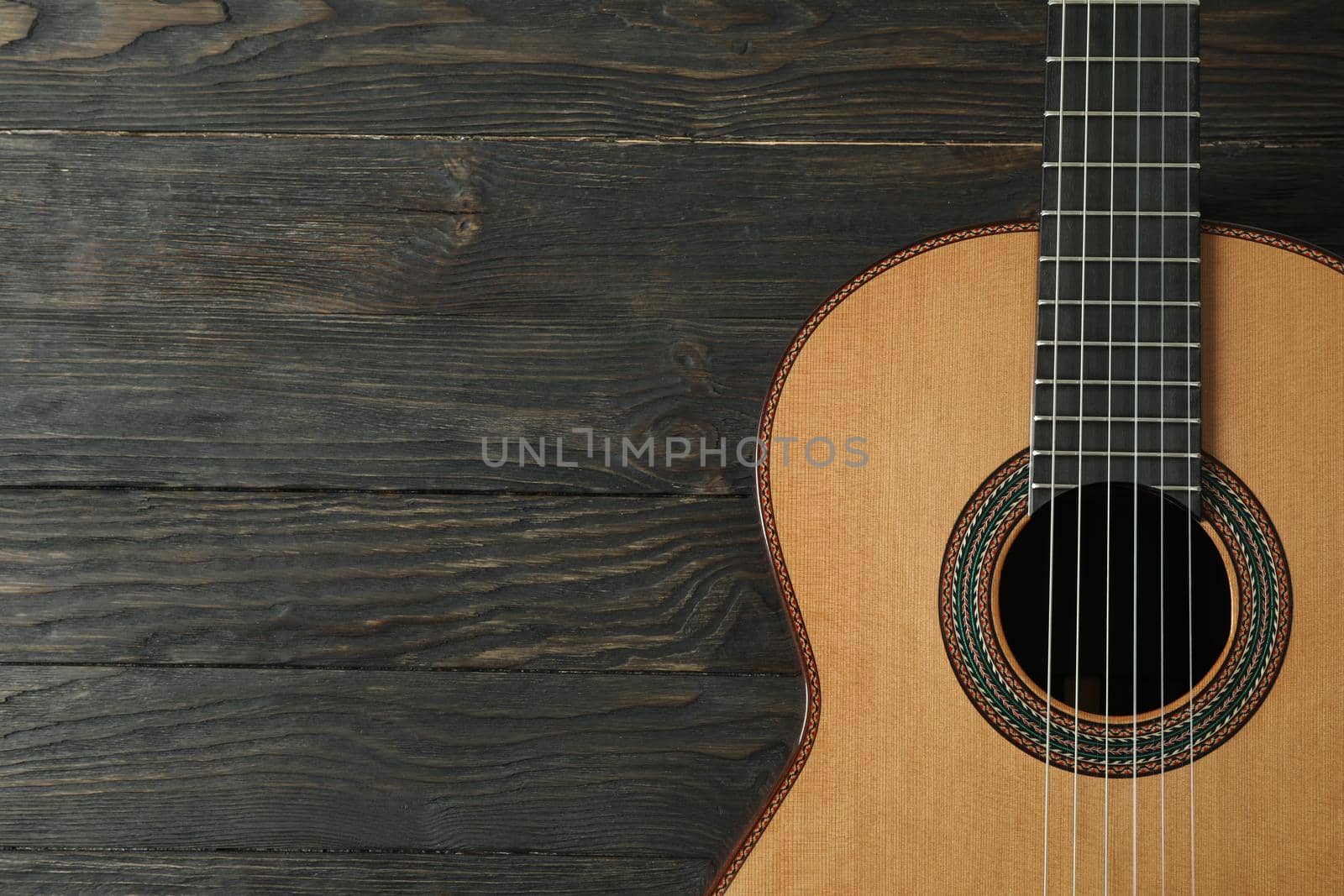 Beautiful six - string classic guitar on wooden background, space for text by AtlasCompany