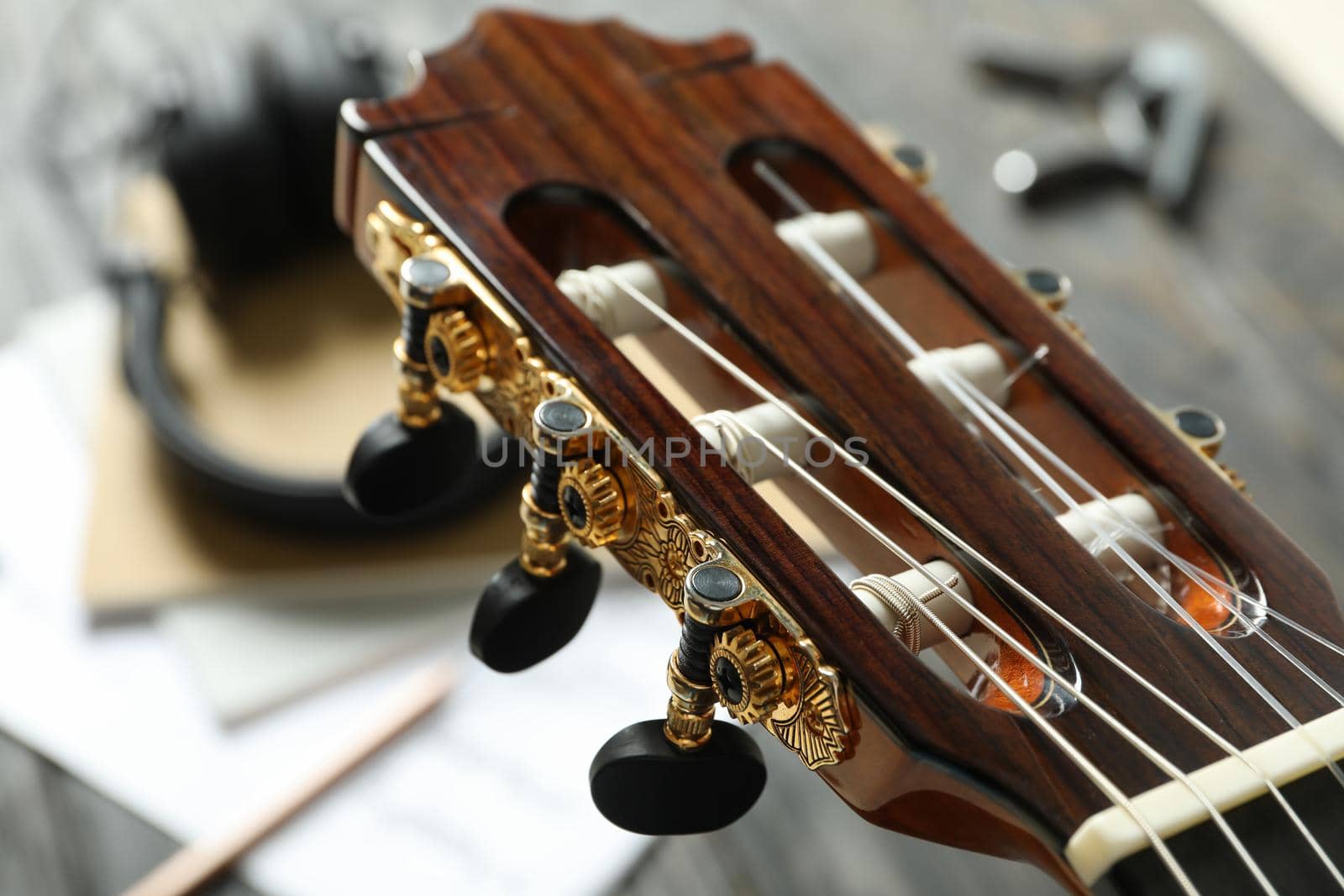 Neck head and music maker accessories against wooden background, closeup