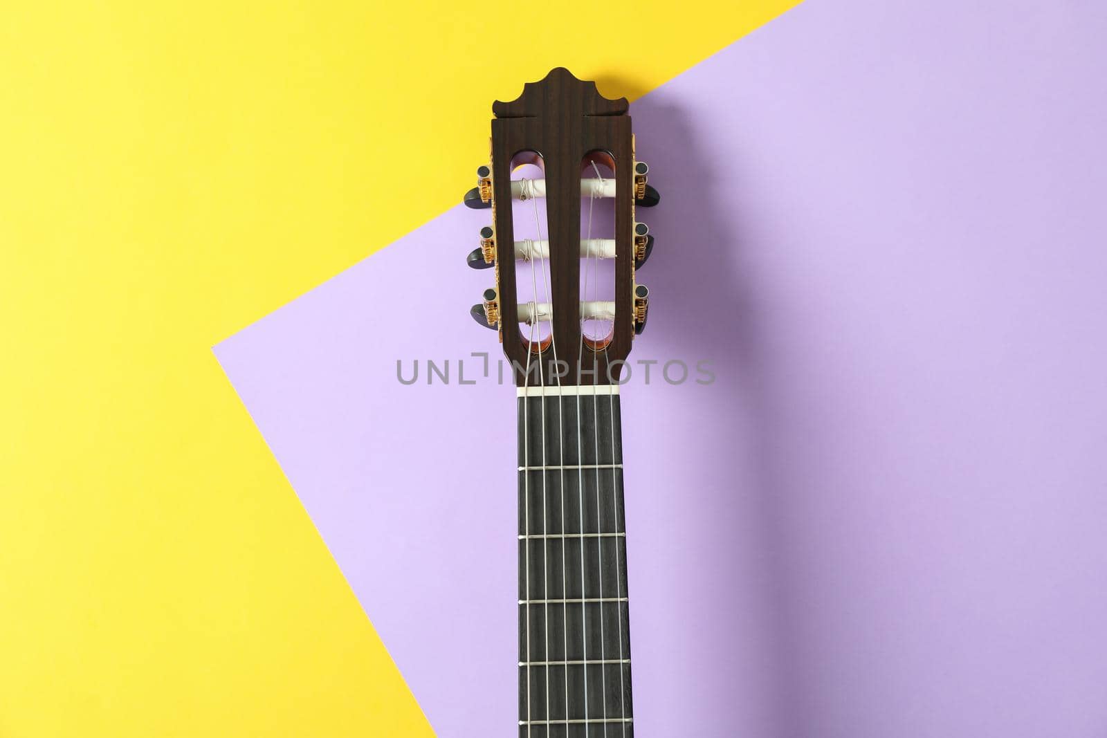 Guitar neck on two tone background, space for text by AtlasCompany