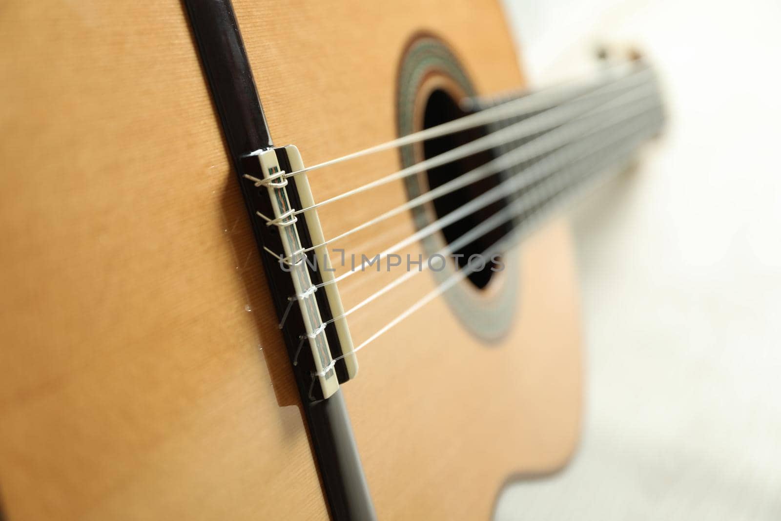 Beautiful six - string classic guitar on white background, closeup