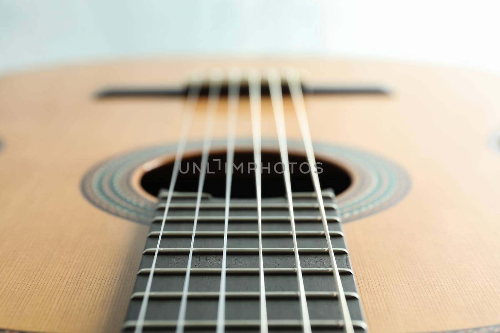 Beautiful six - string classic guitar on white background, closeup