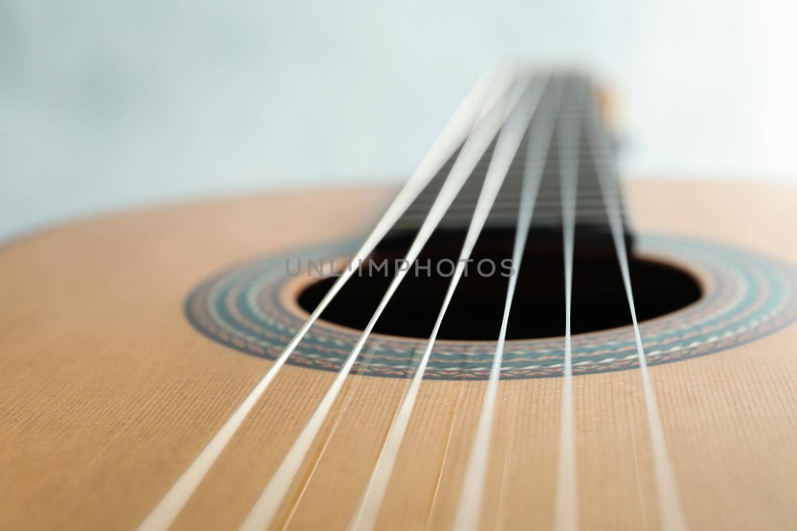 Beautiful six - string classic guitar on white background, closeup