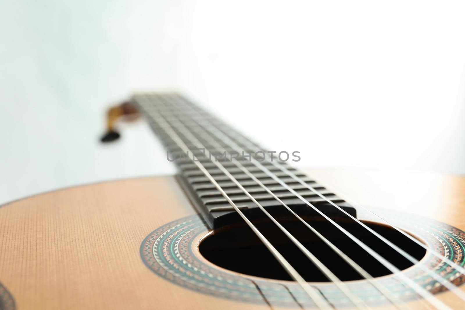 Beautiful six - string classic guitar on white background, closeup