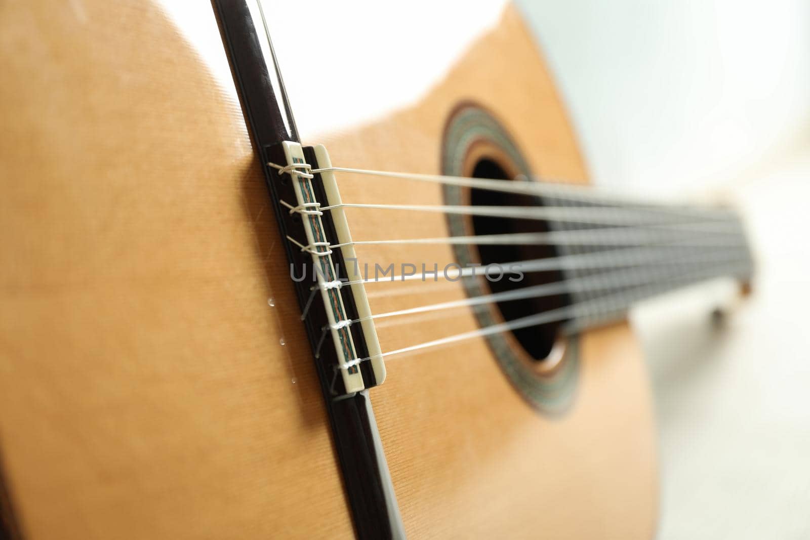 Beautiful six - string classic guitar on white background, closeup