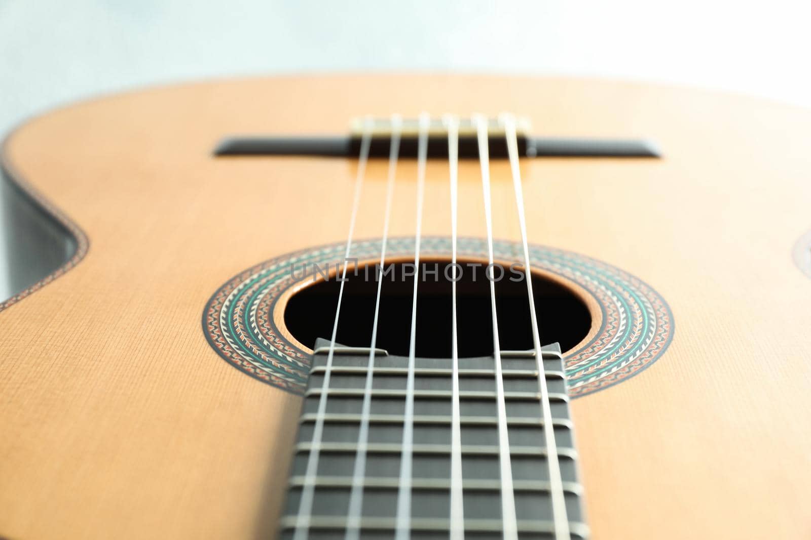 Beautiful six - string classic guitar on white background, closeup