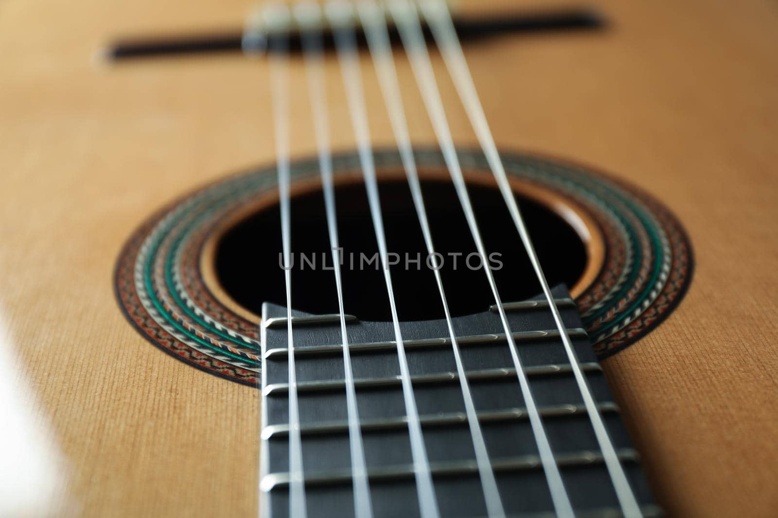 Beautiful six - string classic guitar as background, closeup by AtlasCompany