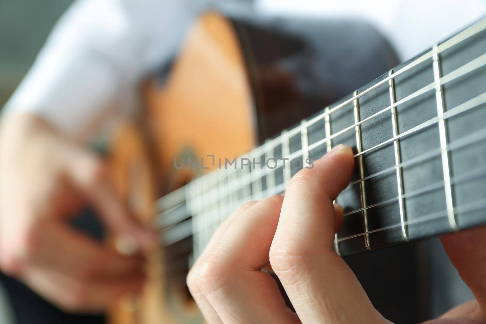 Man playing on classic guitar, space for text