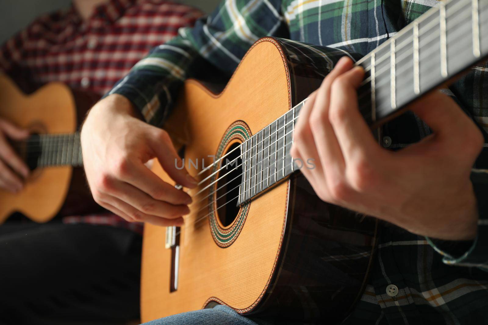 Two guitar players with classic guitars, space for text