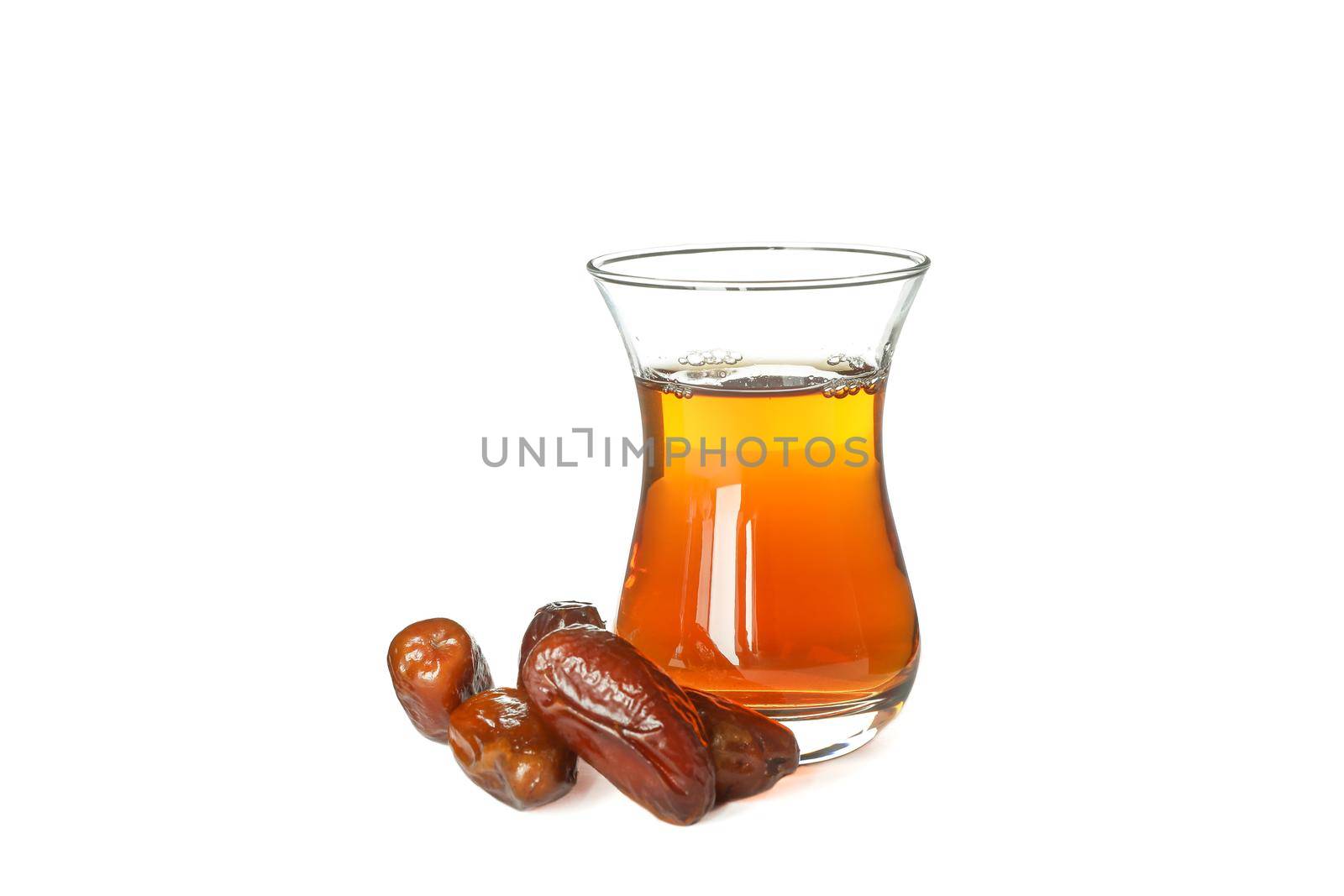 Delicious dates and glass of tea isolated on white background