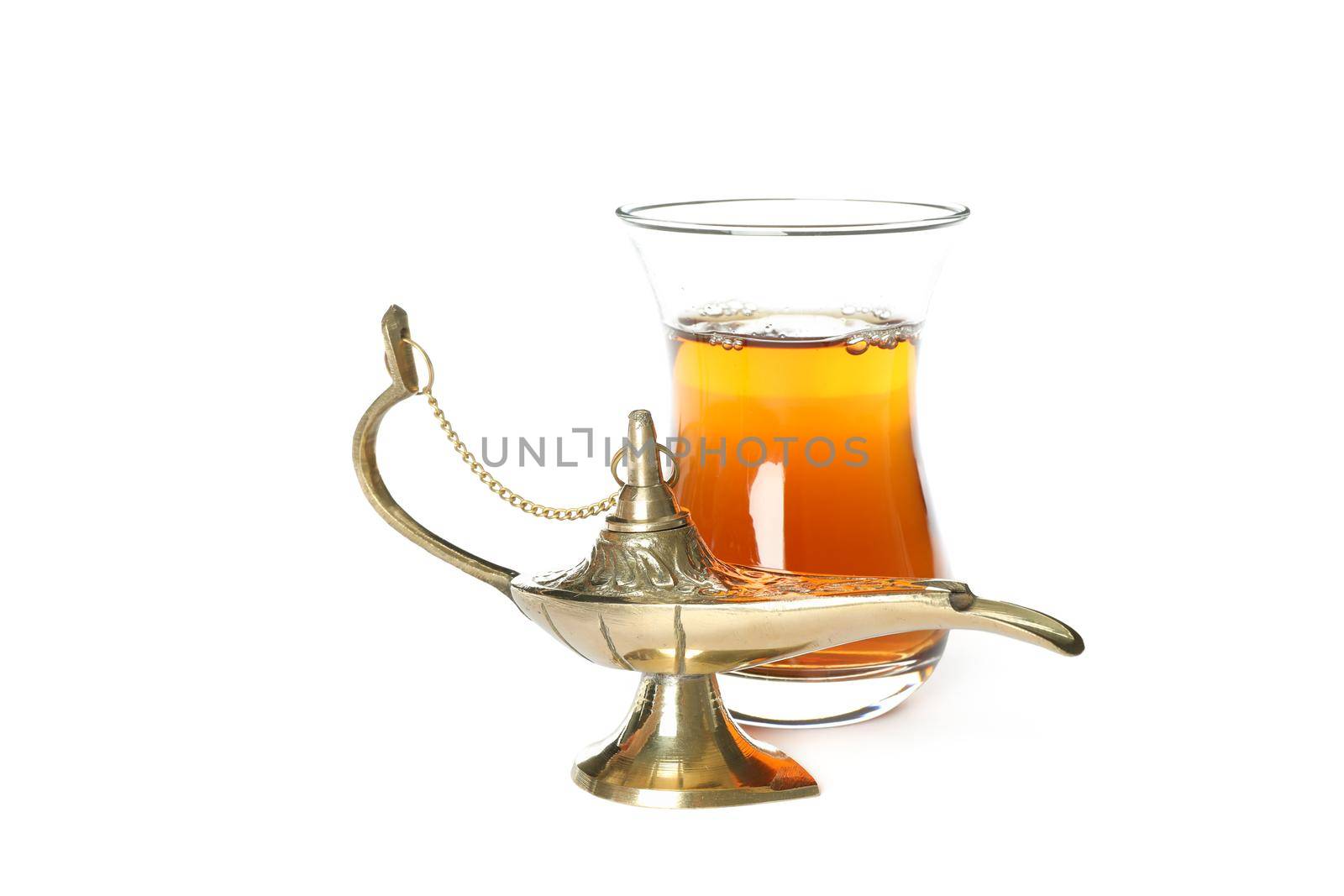 Glass of tea and Aladdin Lamp isolated on white background