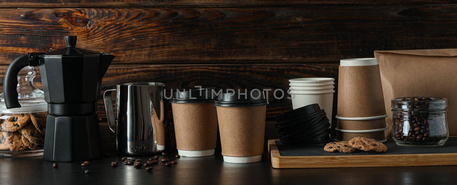 Coffee time accessories on black table against wooden background, space for text. Break time