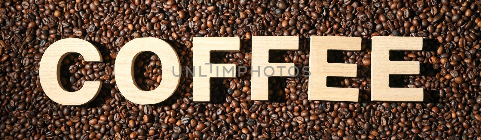 Inscription coffee on beans background, top view and space for text