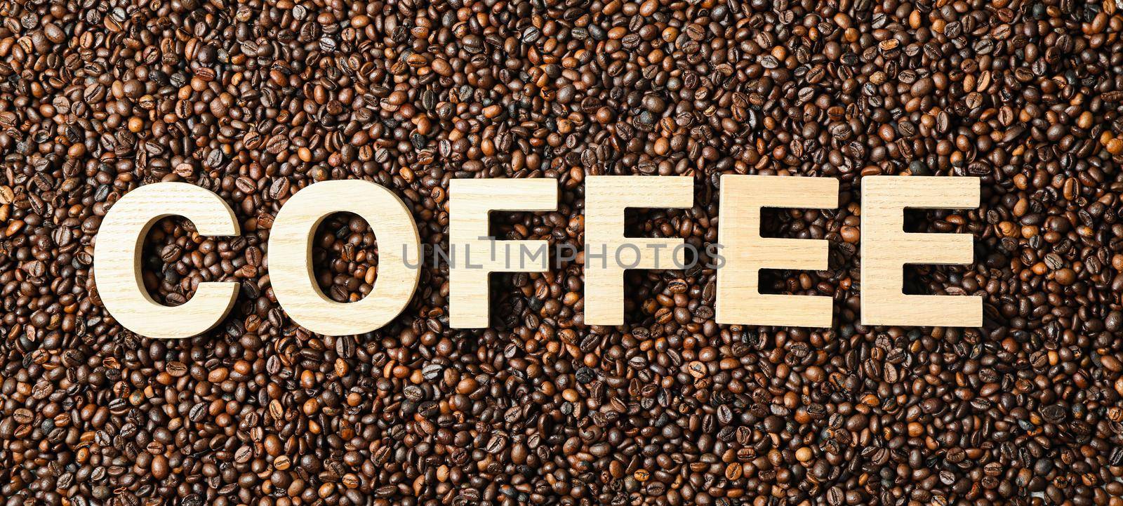 Inscription coffee on beans background, top view and space for text