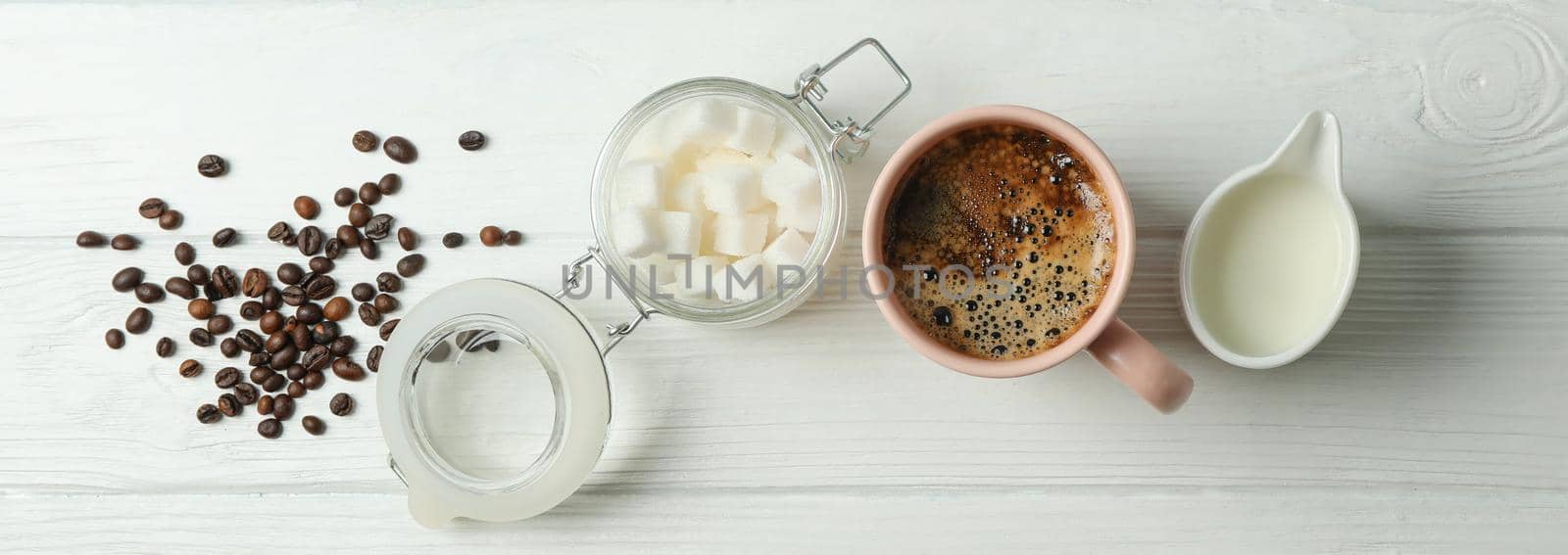 Coffee time accessories on white wooden background, space for text. Break time