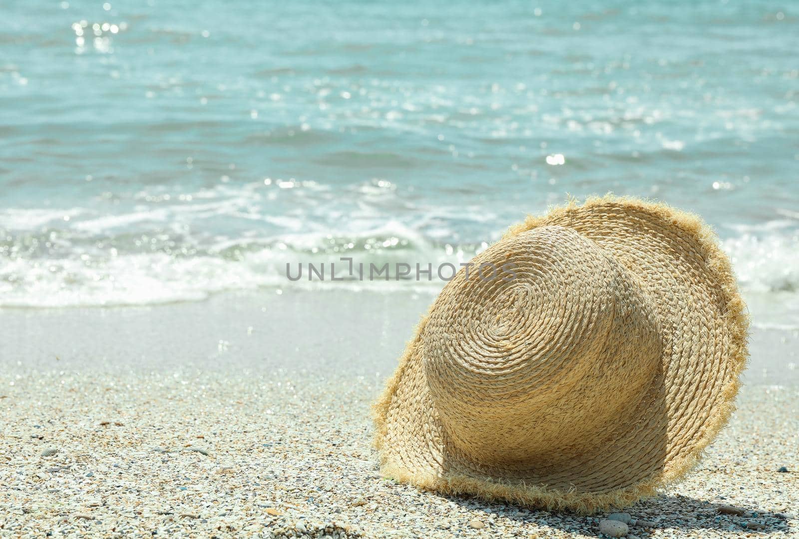 Straw hat on seaside, space for text. Summer vacation background by AtlasCompany