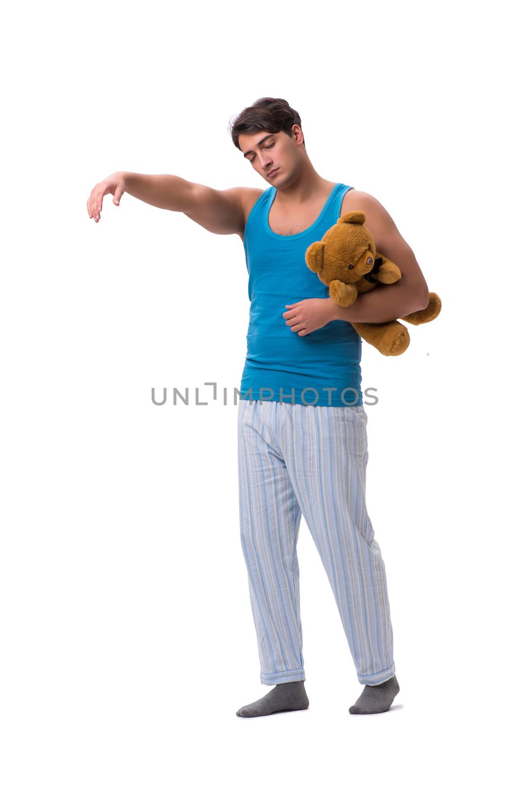 Young man in pajamas with toy animal isolated on white background