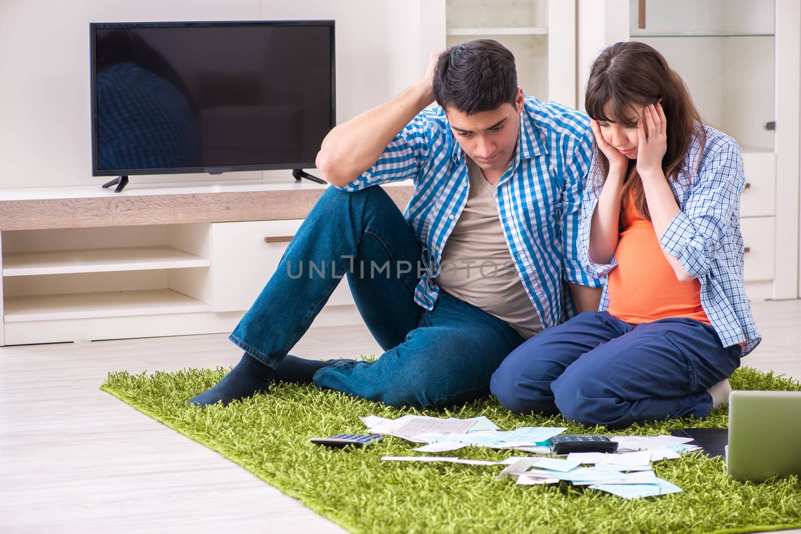 Young family in budget planning concept