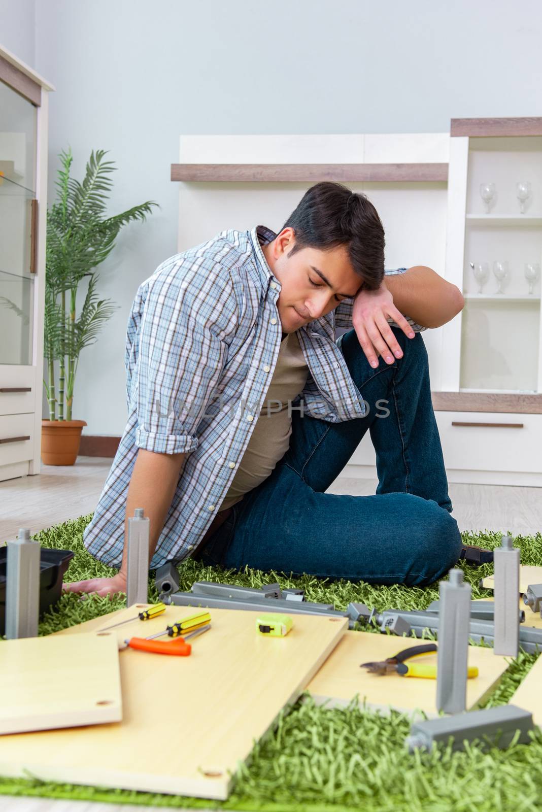 Man assembling furniture at home