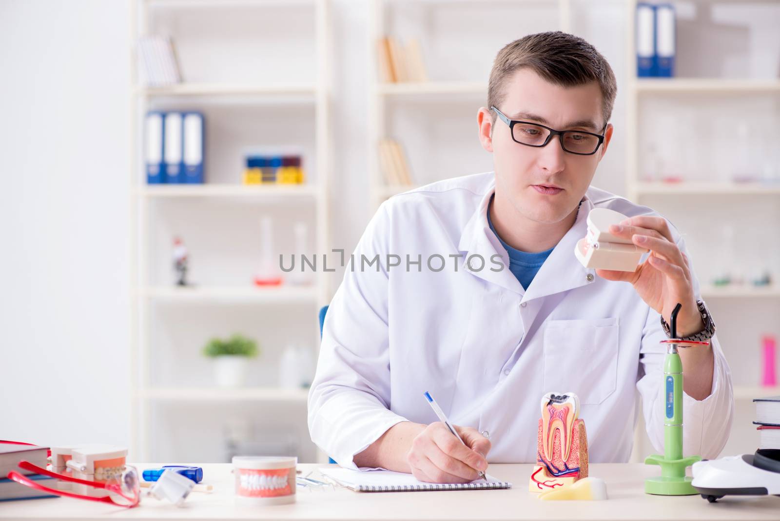 Dentist working teeth implant in medical lab