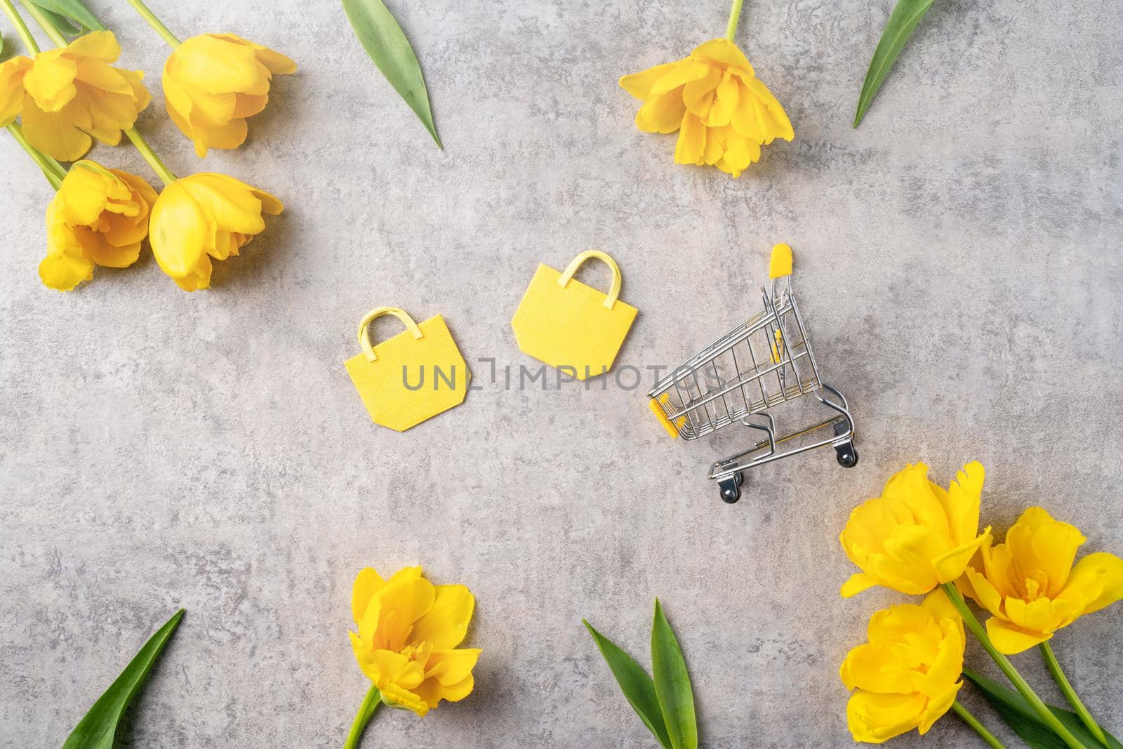 Concept of Mother's day holiday gift shopping greeting design with yellow tulip flower bouquet on gray background
