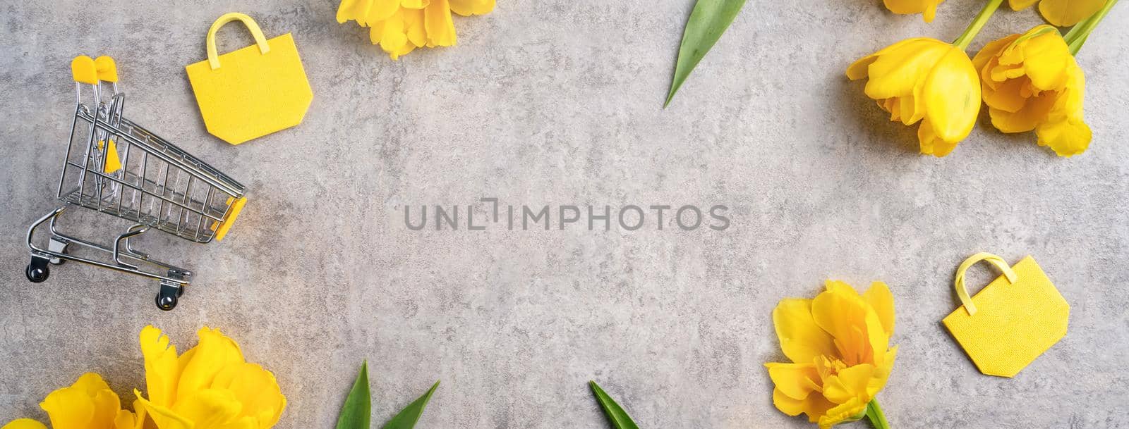 Concept of Mother's day holiday gift shopping greeting design with yellow tulip flower bouquet on gray background
