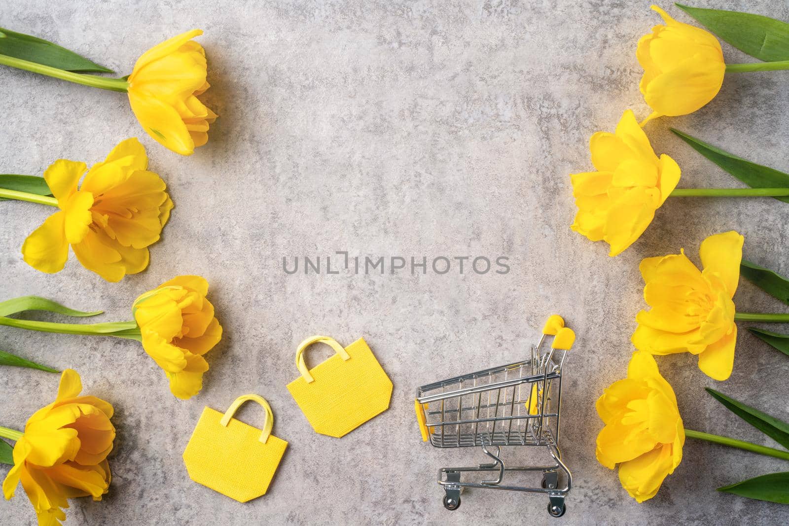 Concept of Mother's day holiday gift shopping greeting design with yellow tulip flower bouquet on gray background